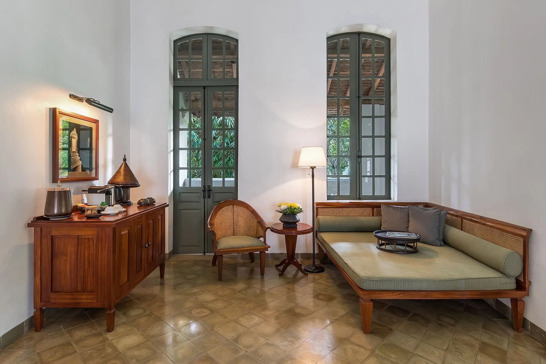 Daybed and tall shutters in a garden room