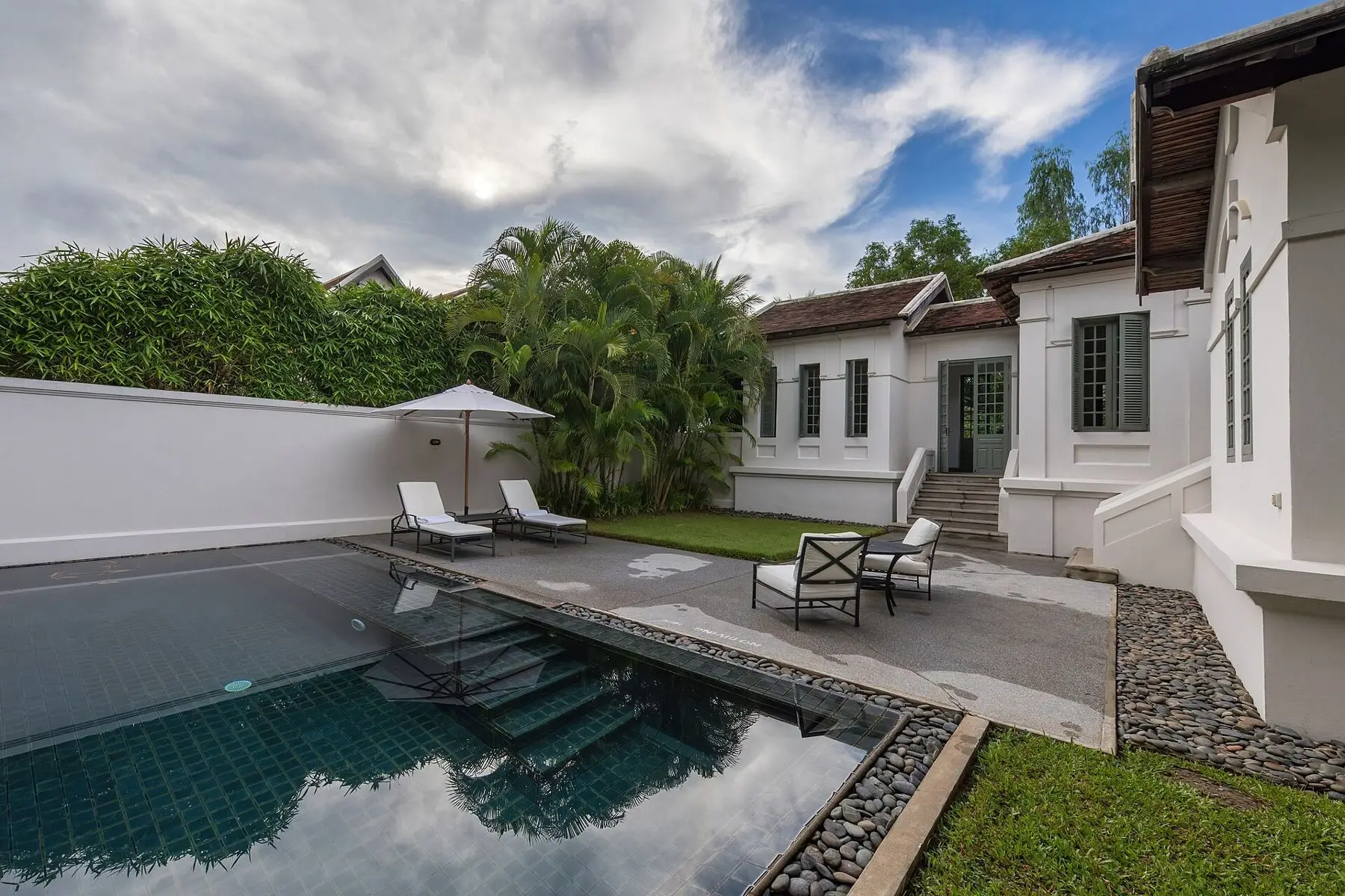 A private plunge pool behind a garden suite